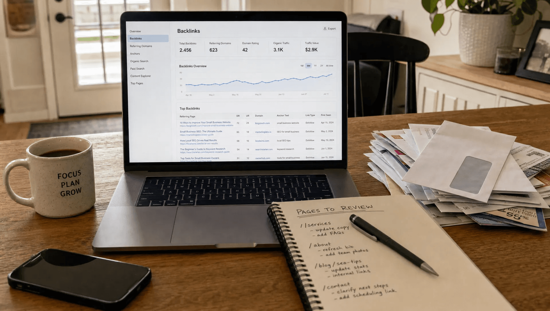 A small business owner checks backlink data at a kitchen table before refreshing a page.