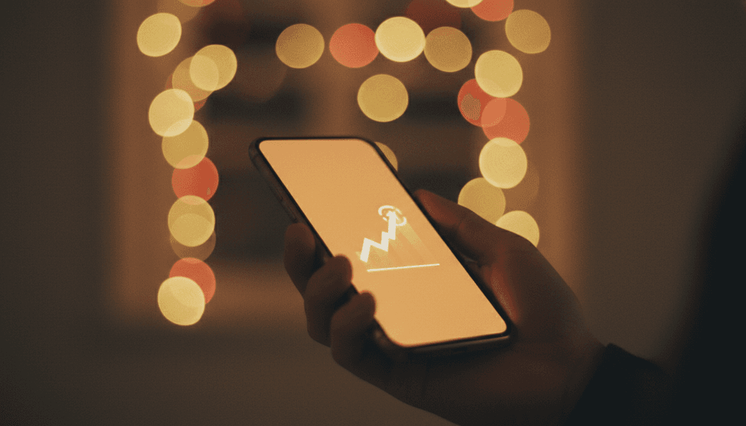 A close-up of a hand holding a smartphone, symbolizing the achievement of a ten million downloads milestone announced on SINA News.